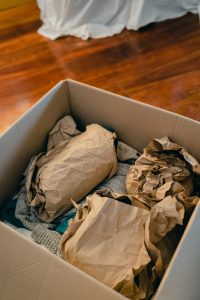 brown packing paper covering items in a cardboard box